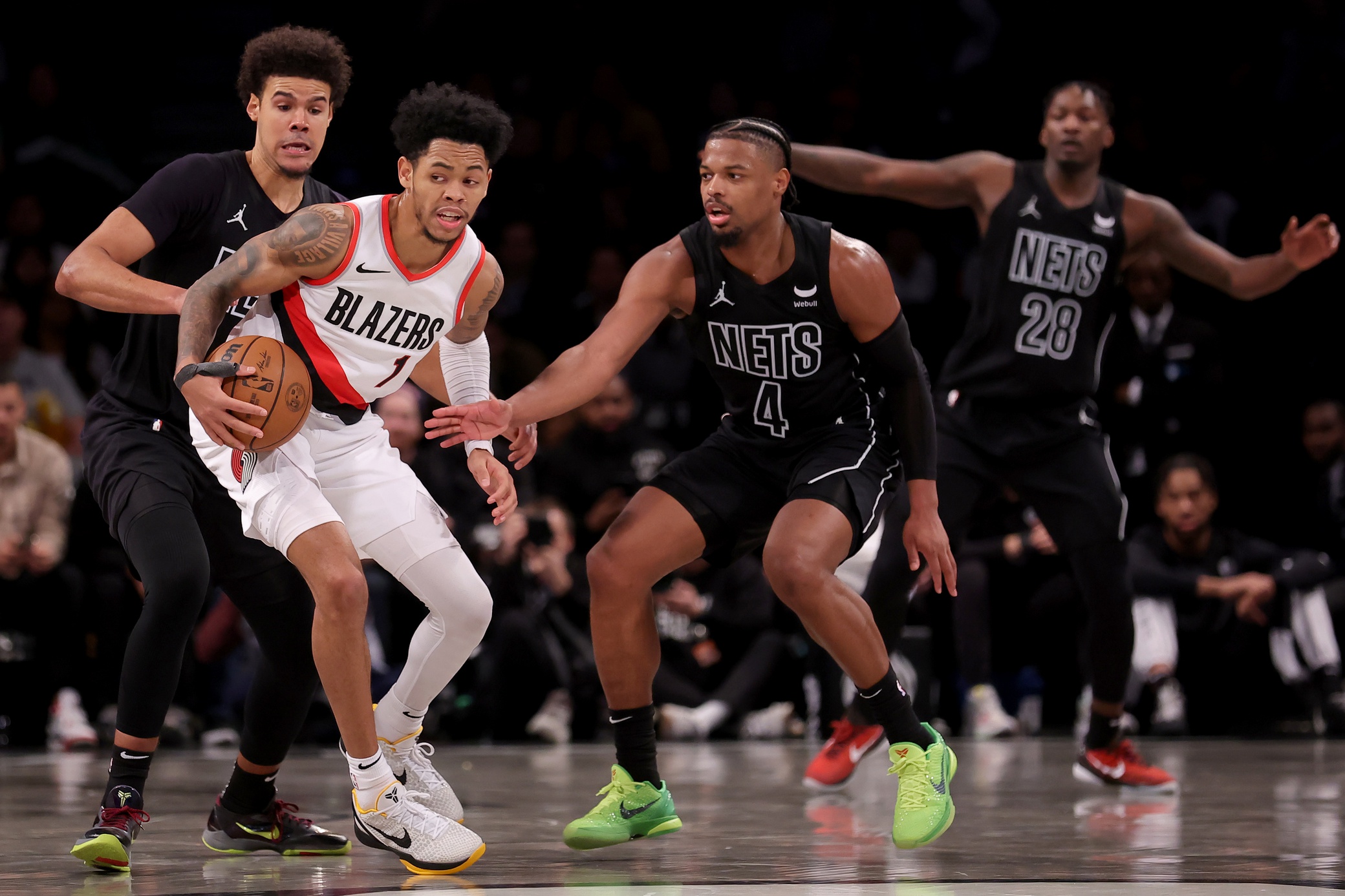 Portland Trail Blazers guard Anfernee Simons (1) controls the ball against Brooklyn Nets forward Cameron Johnson (2) and guard Dennis Smith Jr. (4) and forward Dorian Finney-Smith (28)